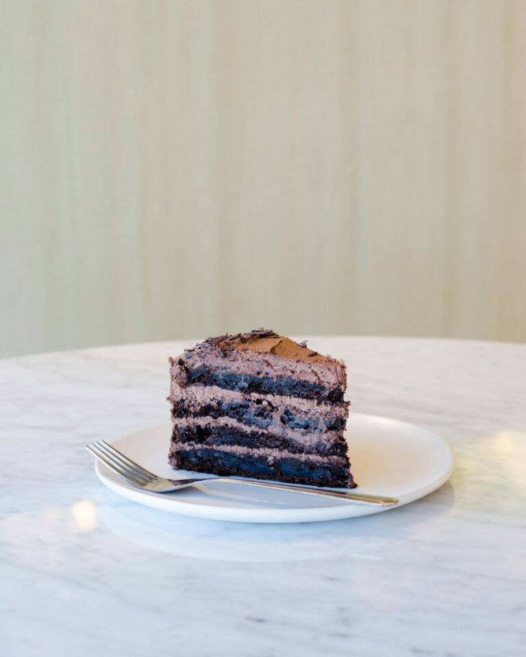 Four layer piece of chocolate cake